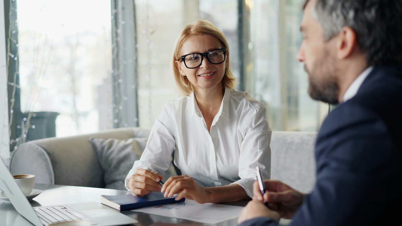 Advisor talking with a client at a table