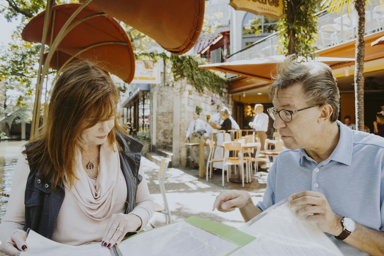 Advisor and an older man reviewing paperwork at an outdoor table