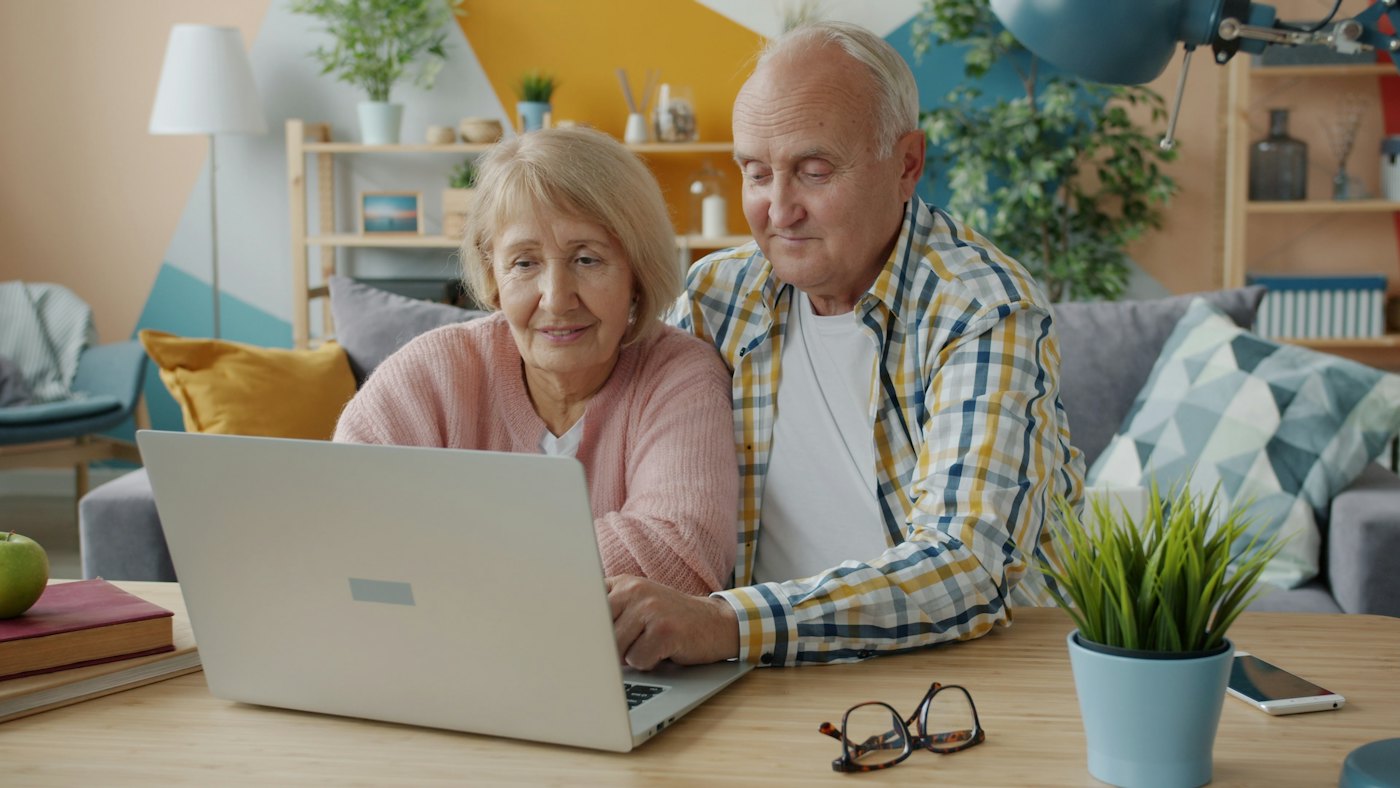 Older couple comparing options on a laptop