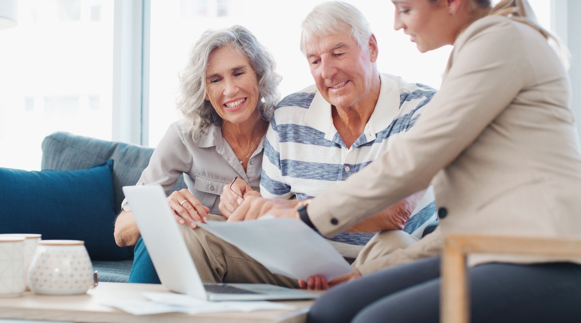 Couple reviewing papers with an advisor at home