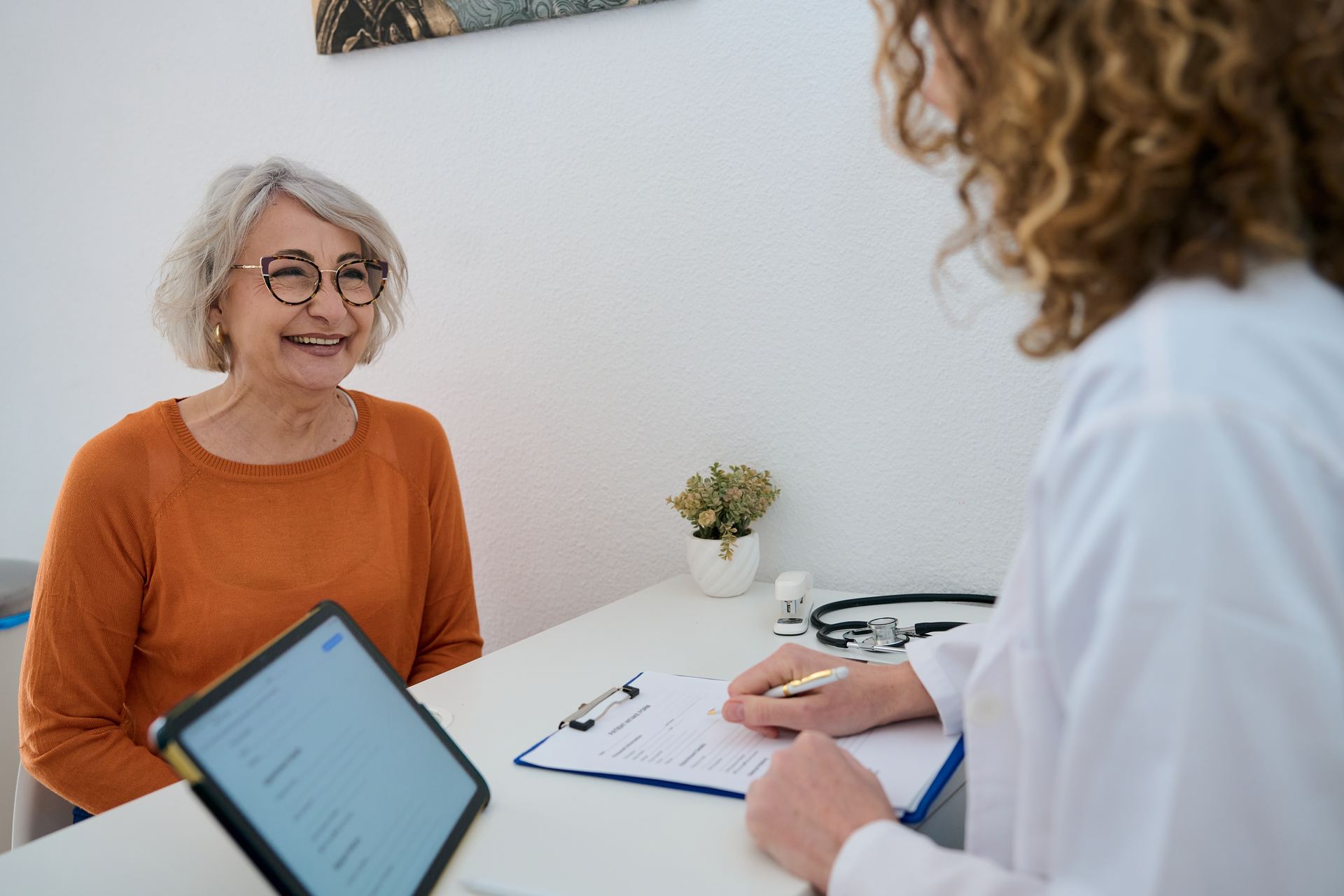 Smiling senior woman at a friendly doctor visit