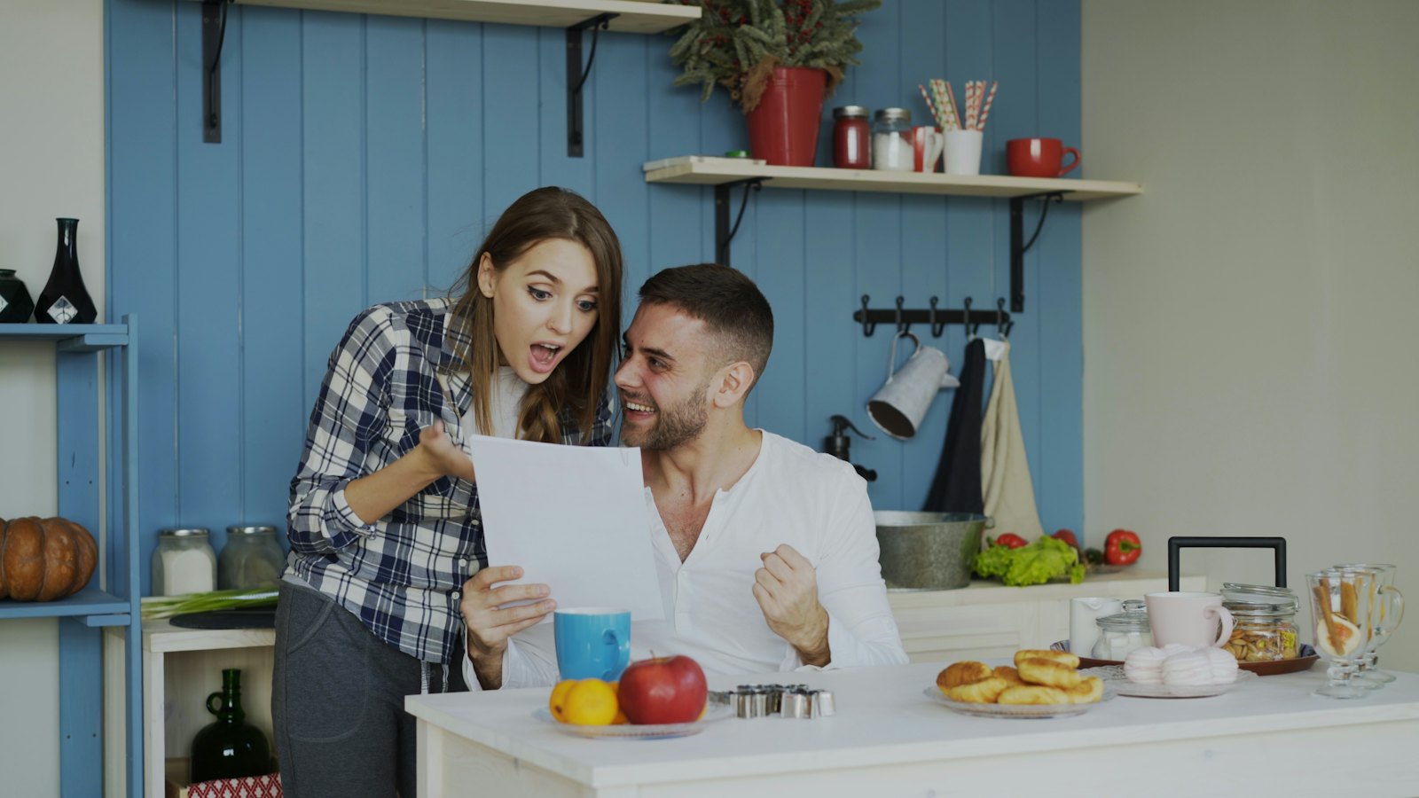 Couple reviewing a document together at their kitchen counter