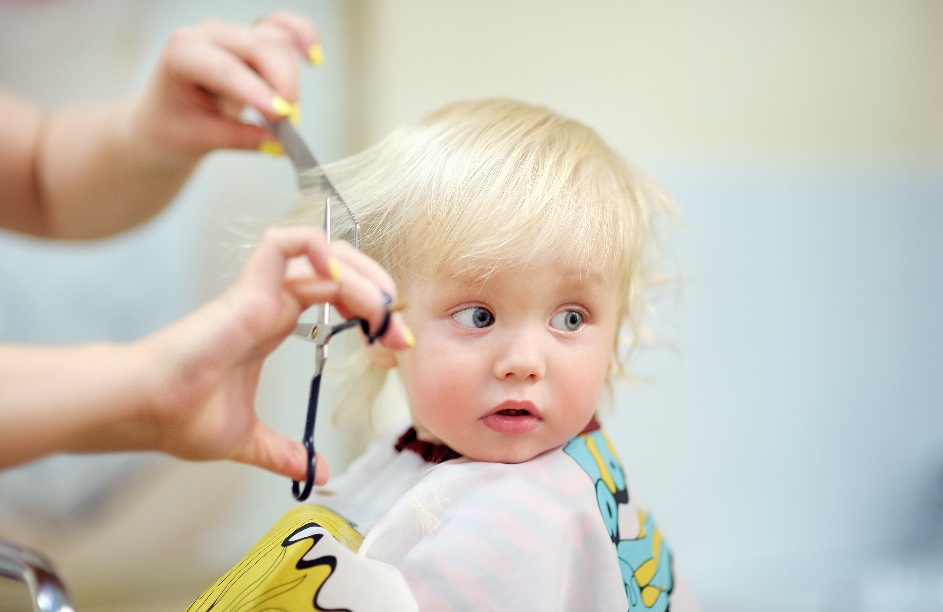 Toddler getting a haircut at Bubble Cuts kids hair salon
