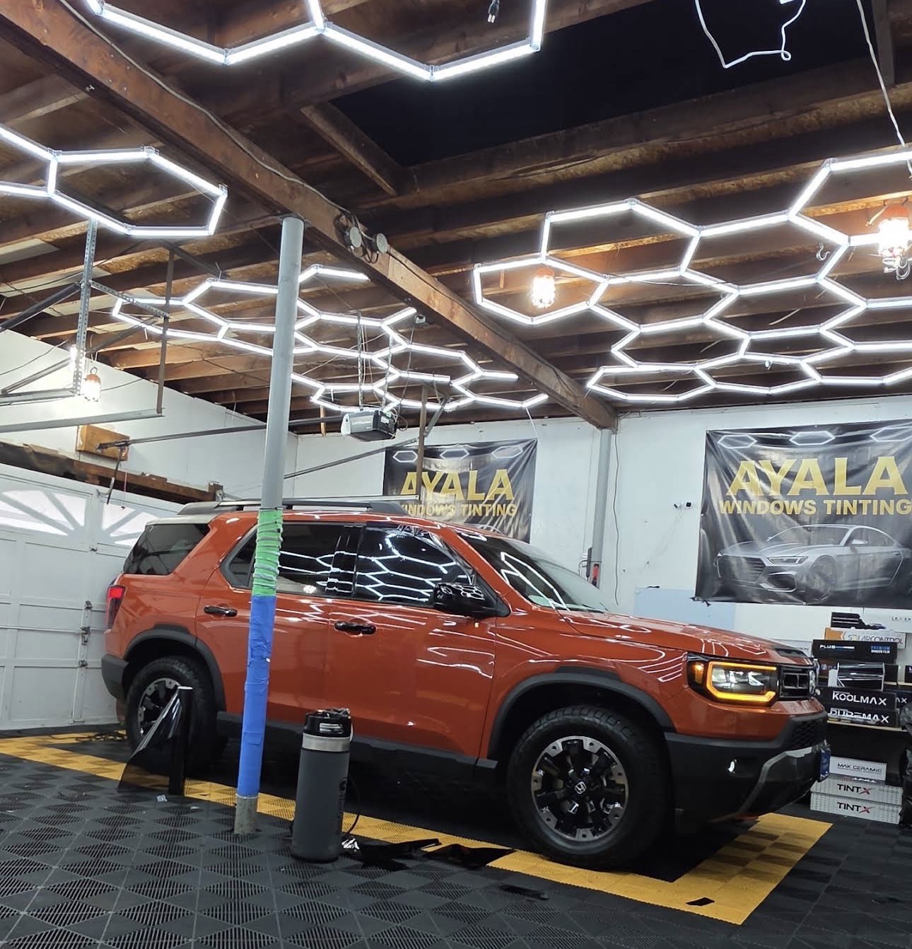 Orange SUV inside the Ayala tint shop