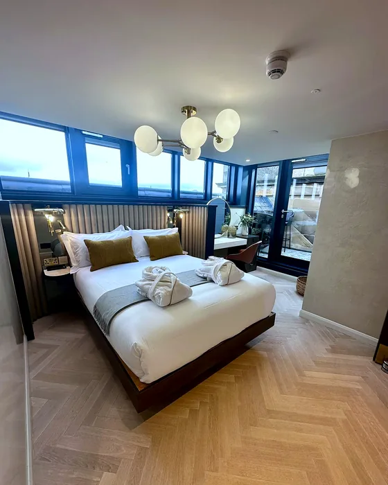 A completed high-end bedroom with bespoke panelling and fitted furniture, part of a full home renovation by CTD Scotland in Edinburgh.