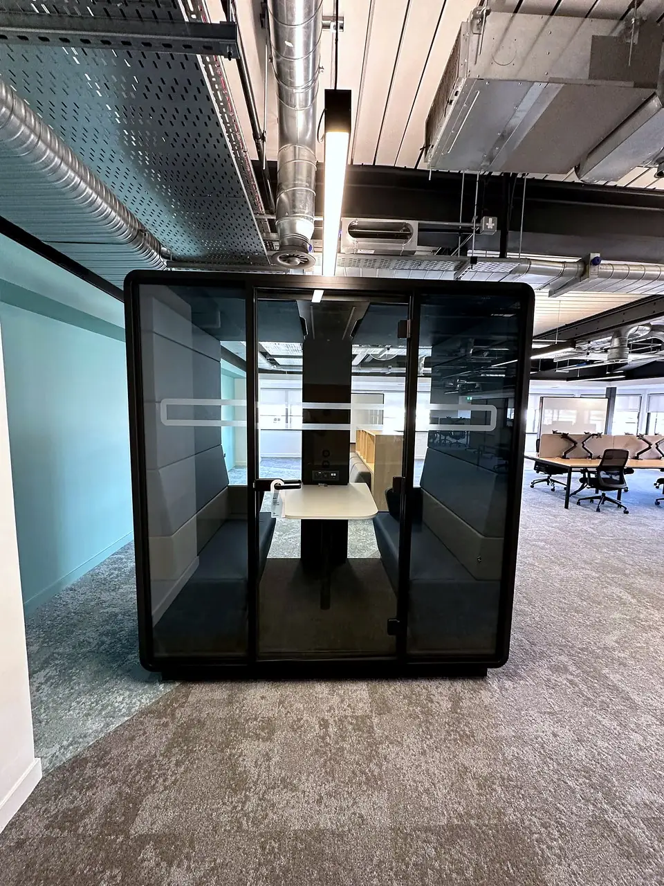 A freestanding glazed meeting pod on the office floor at 33 Castle Street.