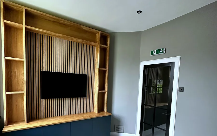 Oak framed media wall with slatted timber panelling by CTD Scotland.