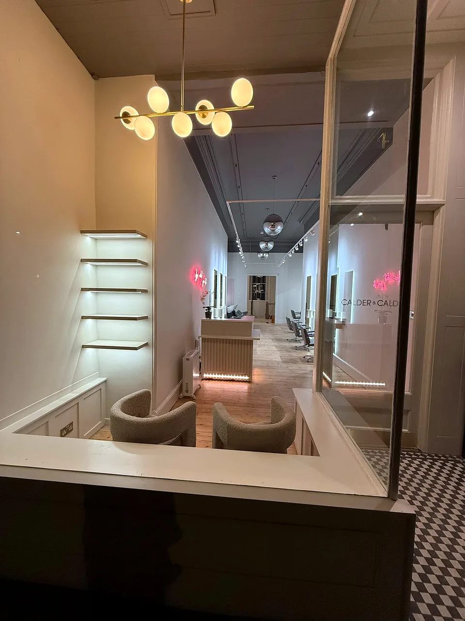 The reception and retail area at Calder & Calder, under feature globe lighting.