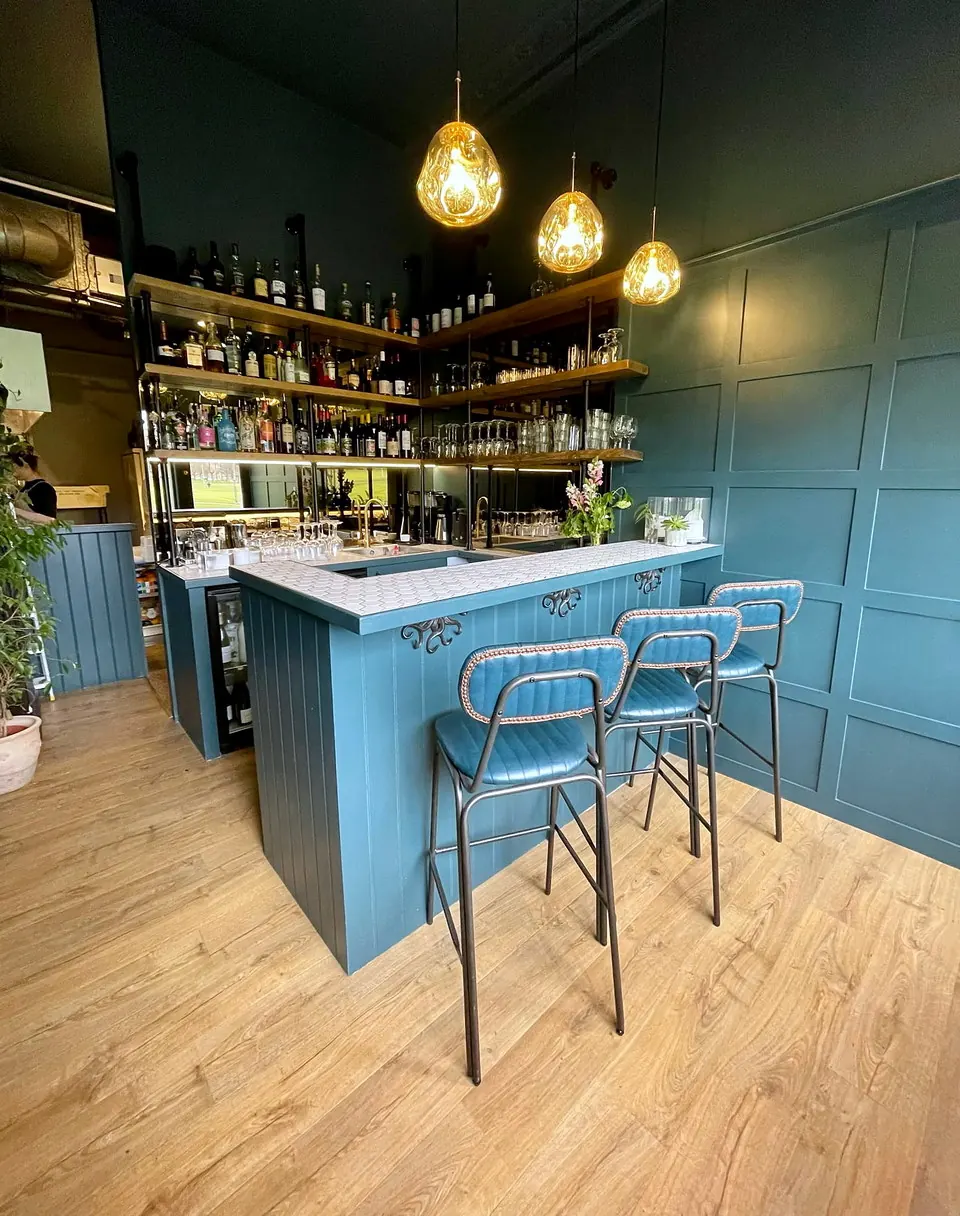 The teal bar counter and pendant lighting at Leftfield, Edinburgh.