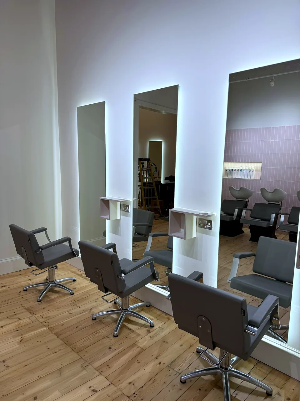 Styling stations with full-height mirrors and timber flooring at Calder & Calder.