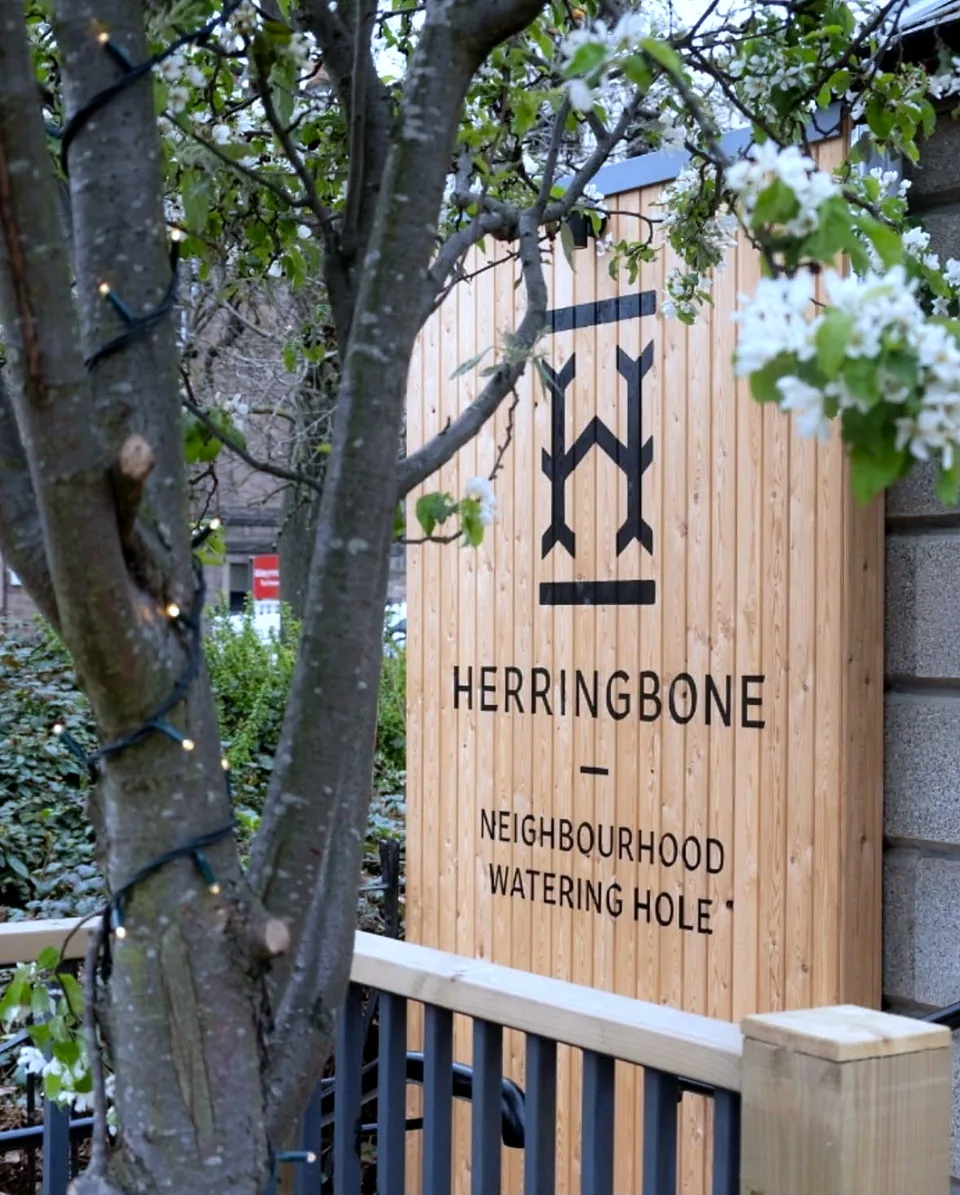 Timber signage at the entrance to Herringbone, Abbeyhill.