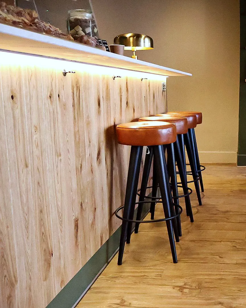 The timber-clad bar counter and leather-topped stools at Lounge 33, Edinburgh.