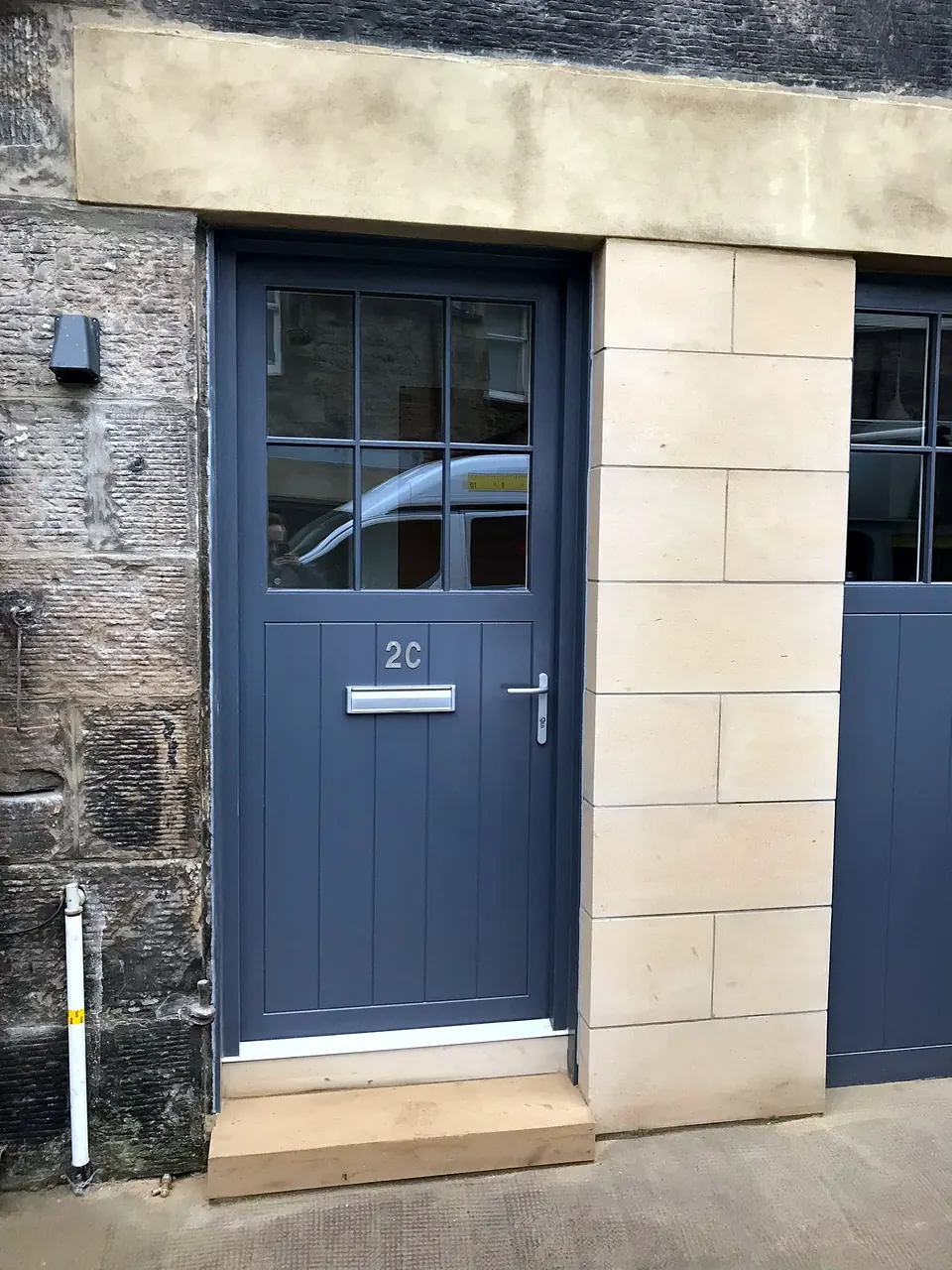 The entrance door and stone frontage of the converted garage at Wemyss Mews, Edinburgh.