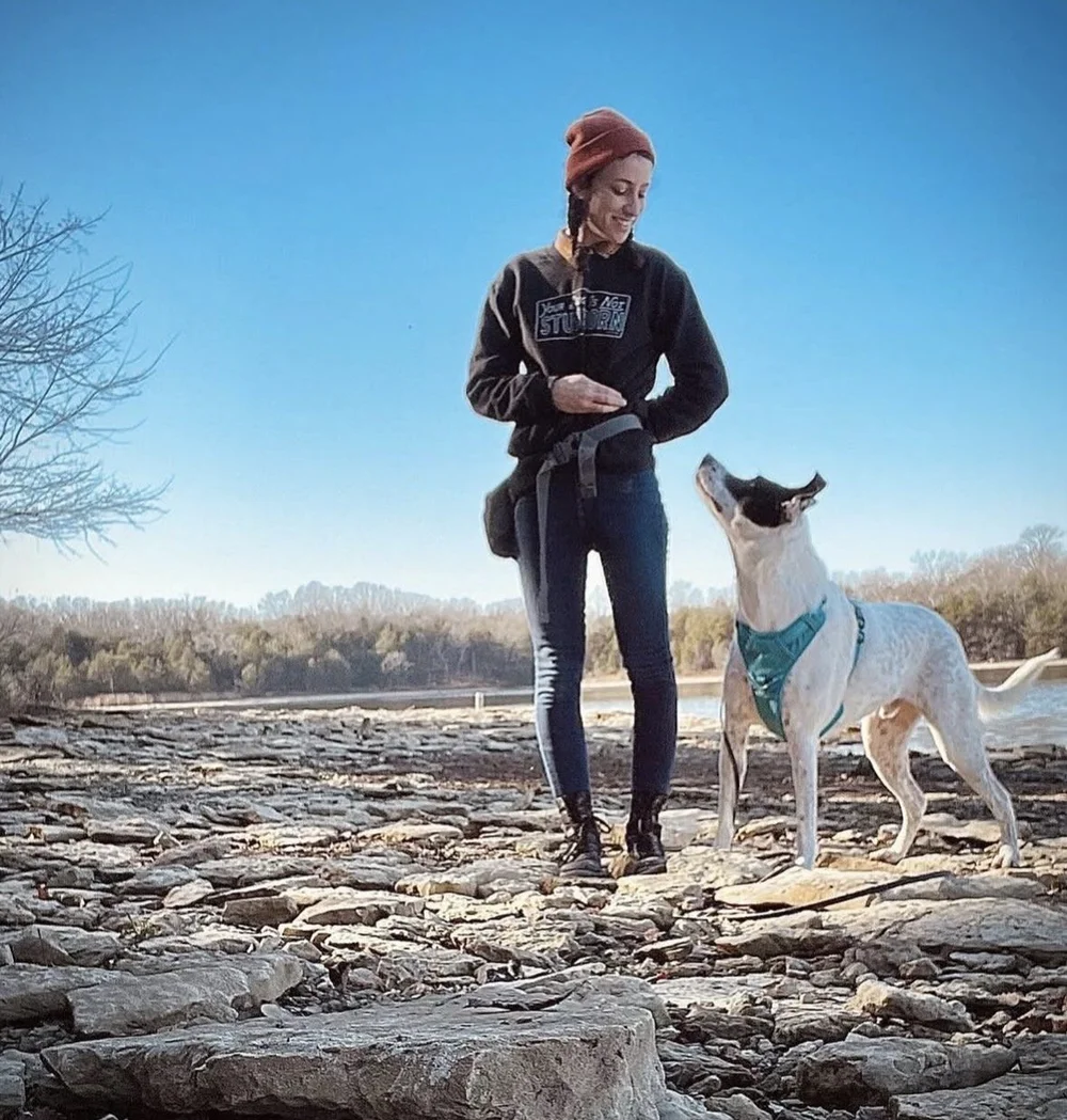 Jenna Slutzky, founder of The Canine Enrichment Co., spending time with a dog outdoors