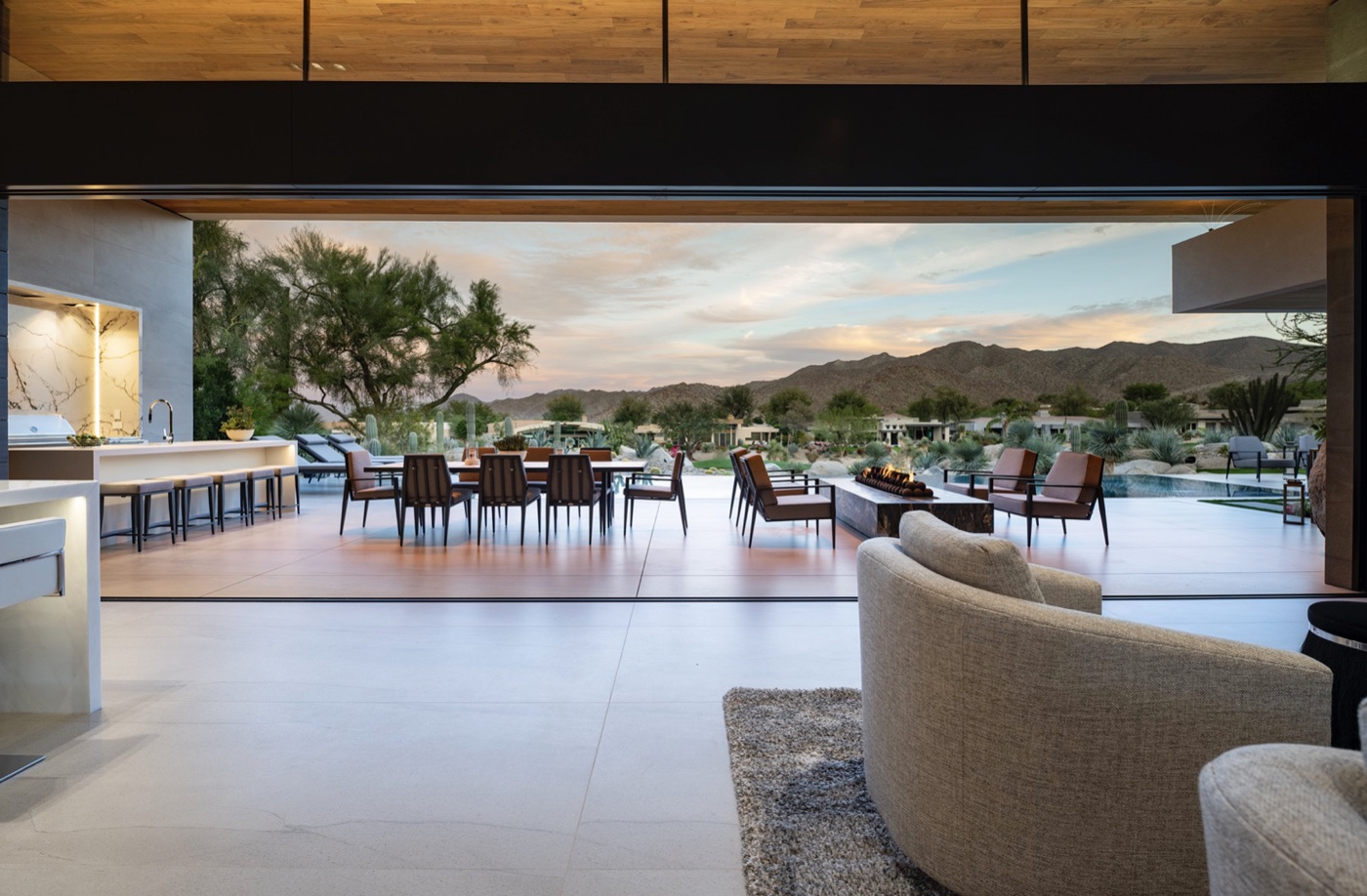 Open-concept indoor-outdoor living with retractable glass walls