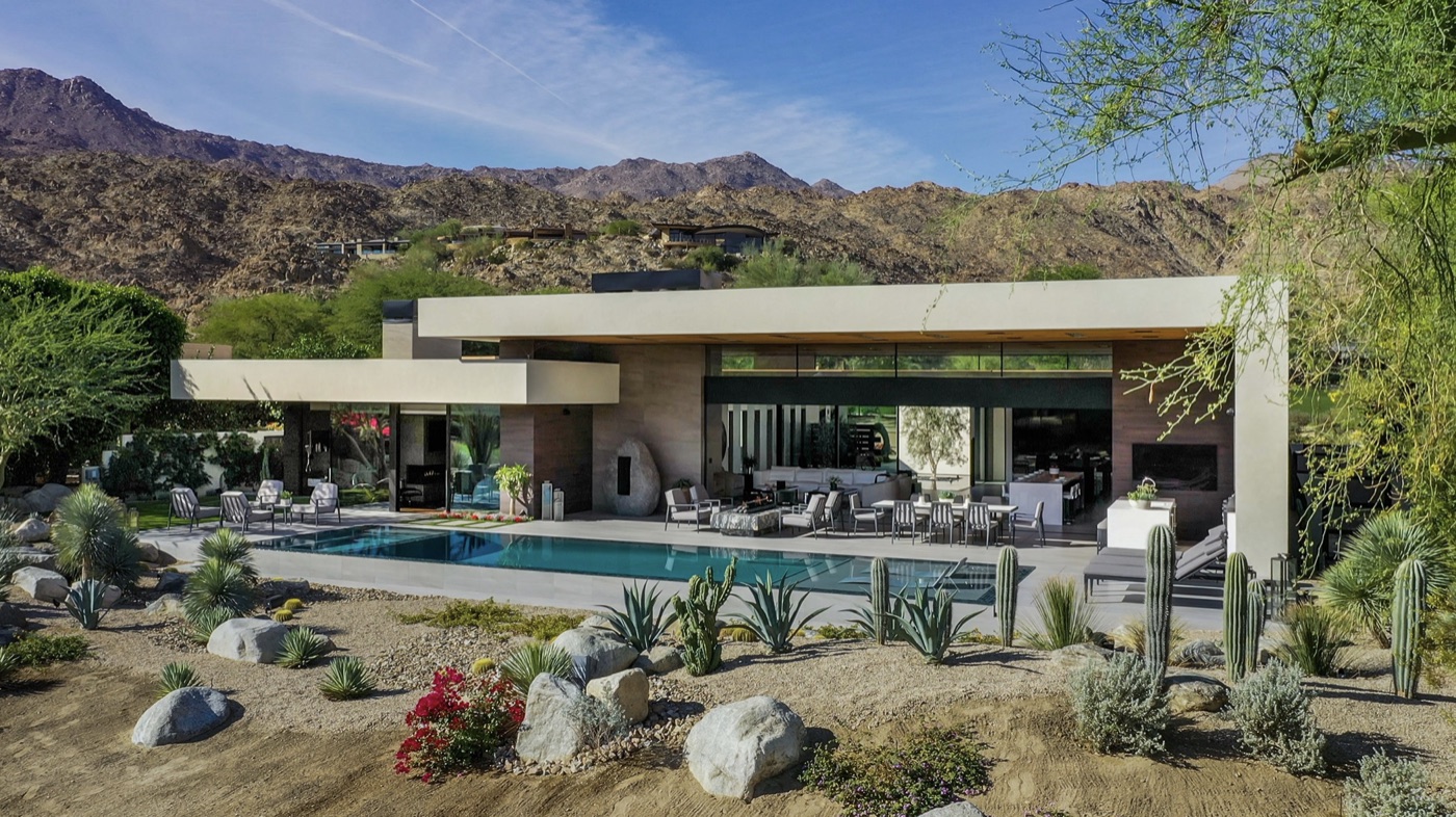 Desert-modern estate with pool and native landscaping against the mountains