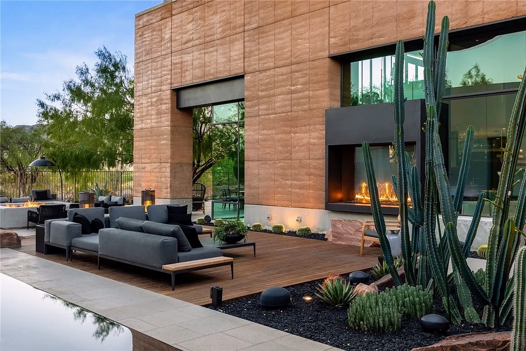 Outdoor lounge with linear fireplace and desert garden