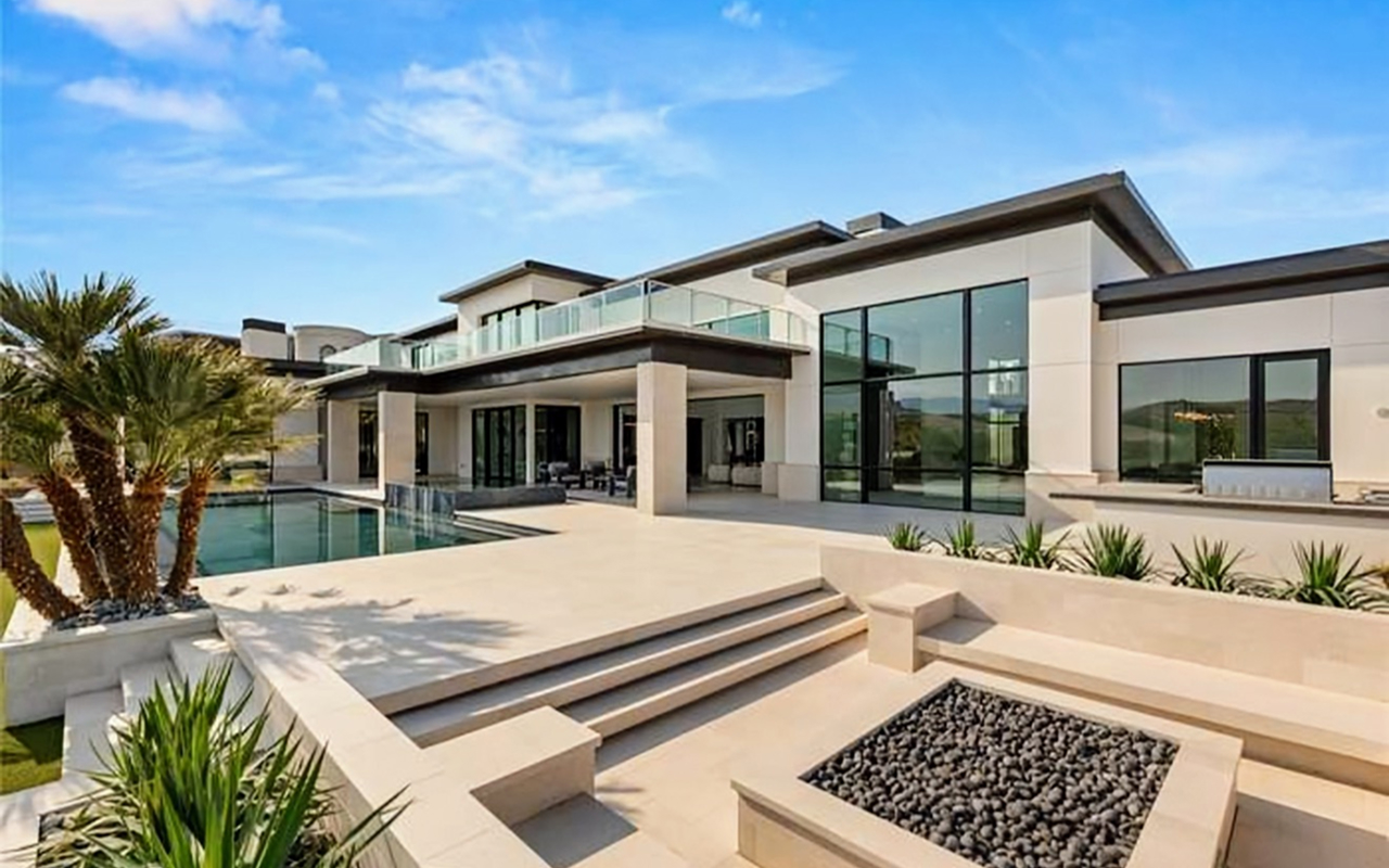 Cream stone estate with infinity pool, terraced steps and fire pit