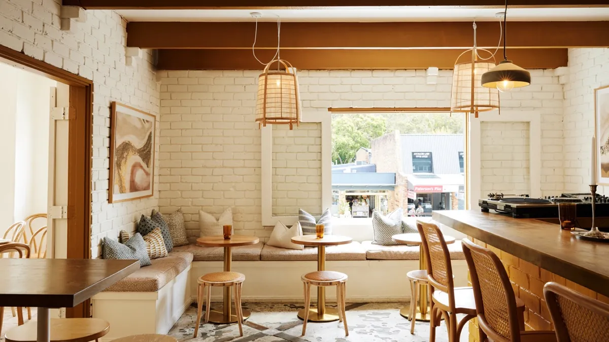 Bar seating at Elvina with timber stools and coastal light