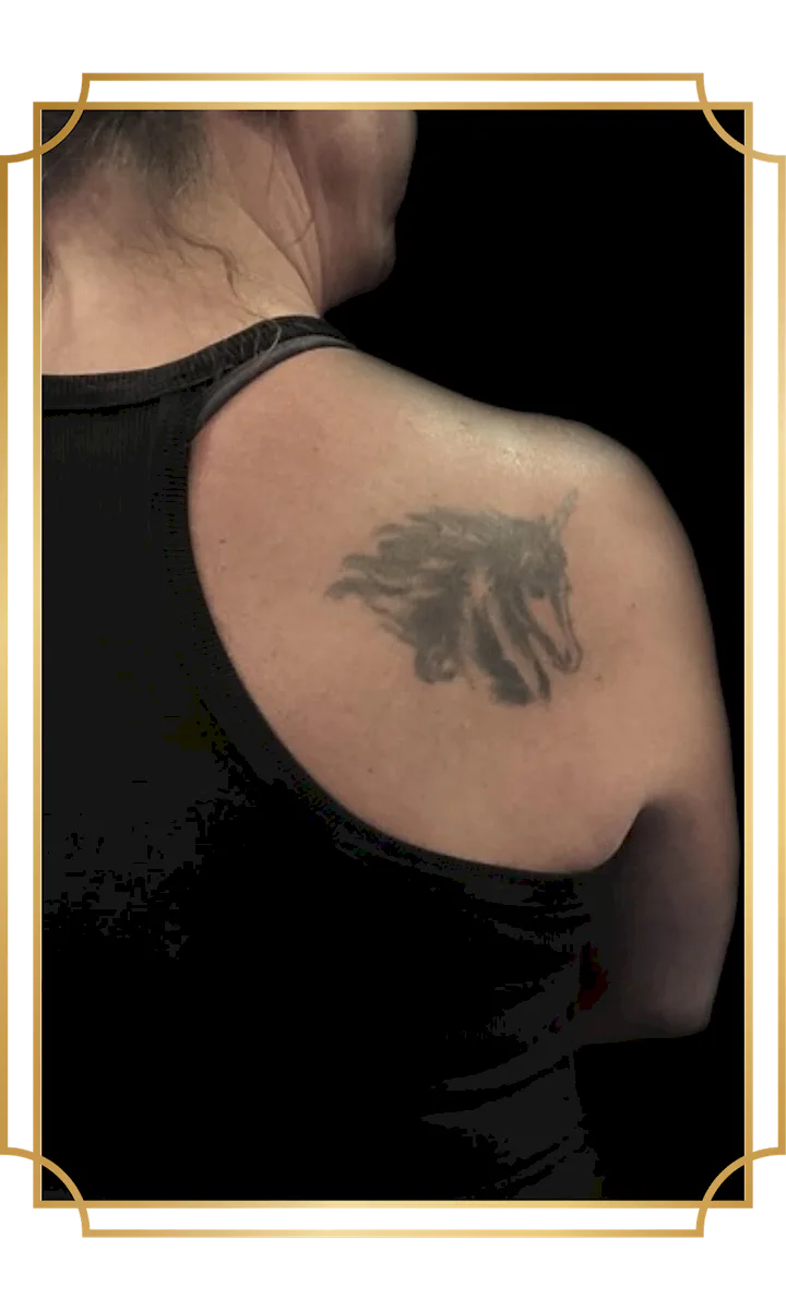 Faded tattoo on the shoulder blade before a tattoo cover-up
