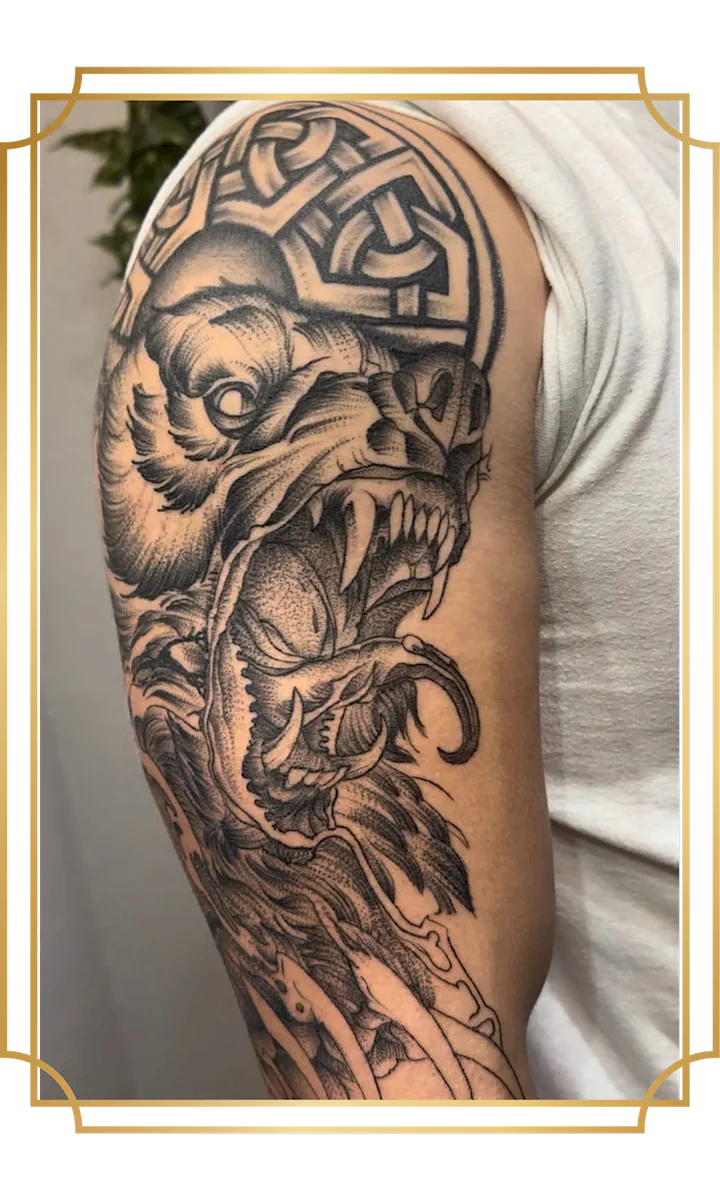 Blackwork snarling dog and skull tattoo on the upper arm
