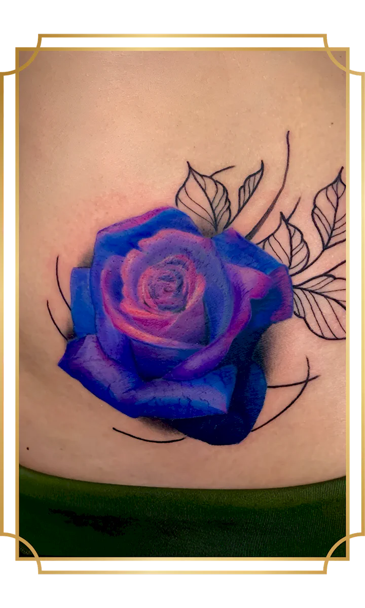 Blue and purple rose tattoo with black botanical linework on the lower back