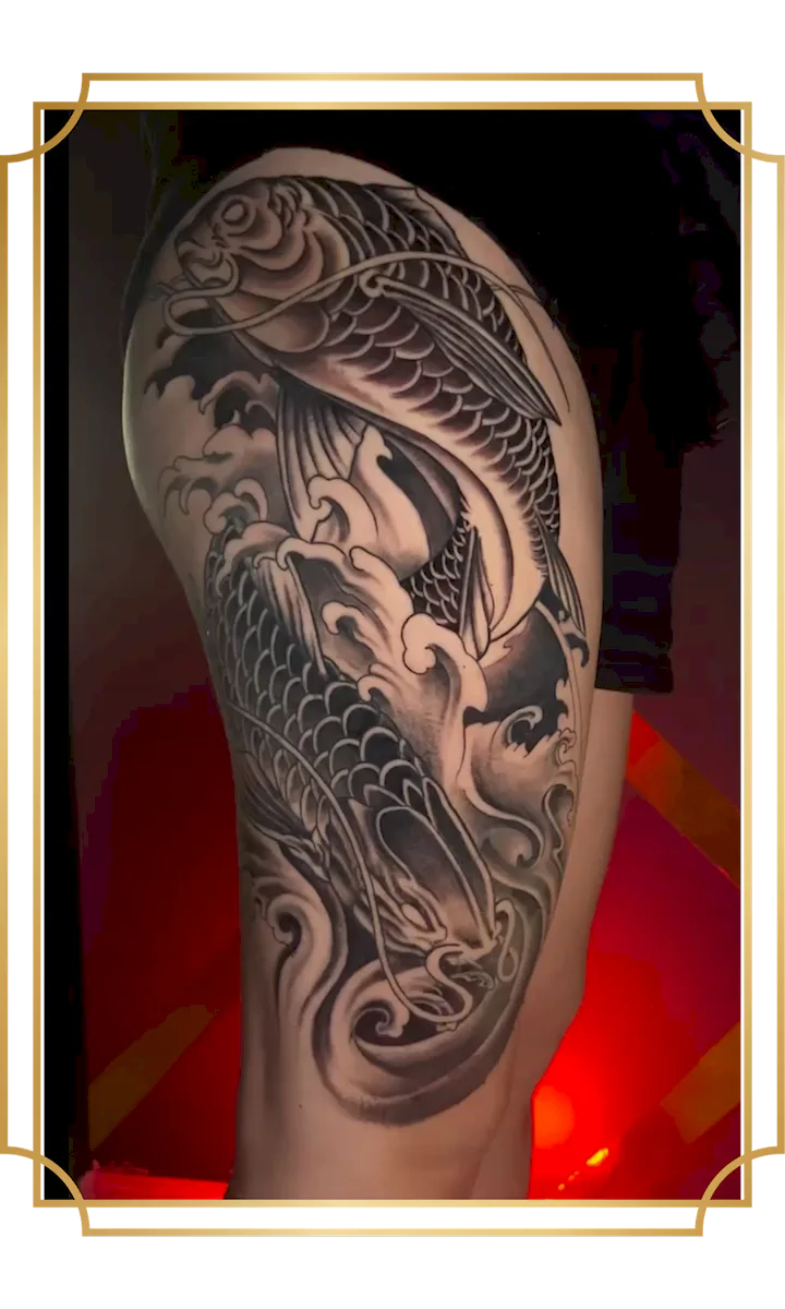 Black and gray Japanese koi fish tattoo with flowing waves on the leg