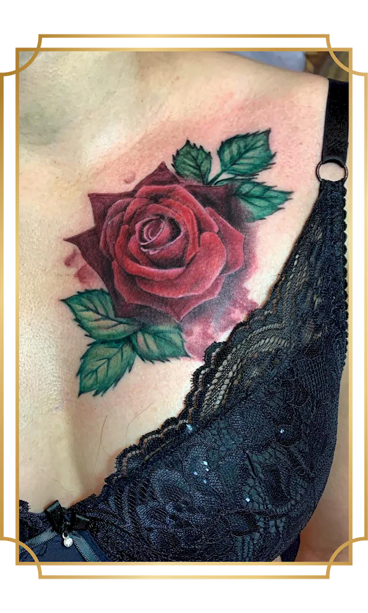 Realistic red rose tattoo with green leaves on the upper chest