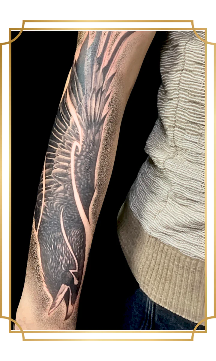 Black and gray raven tattoo with outstretched wings and dotwork shading on the forearm