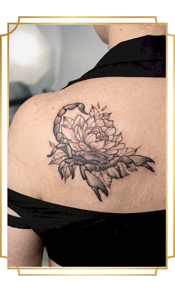 Illustrative fine-line scorpion and peony shoulder-blade tattoo by Alek the Saint, finished with precise linework and stipple shading