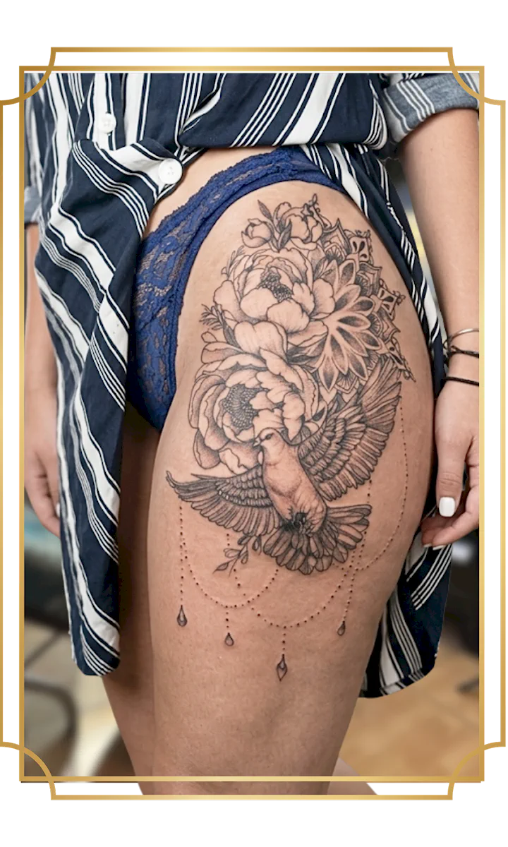 Ornamental fine-line thigh tattoo by San Marcos artist Alek the Saint, featuring a spread-wing owl, peonies, a mandala and hanging jewel details