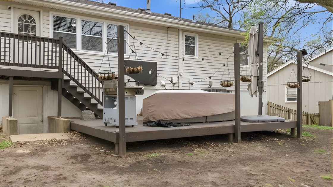 Backyard deck with hot tub and outdoor entertaining space at Olathe KS home for sale