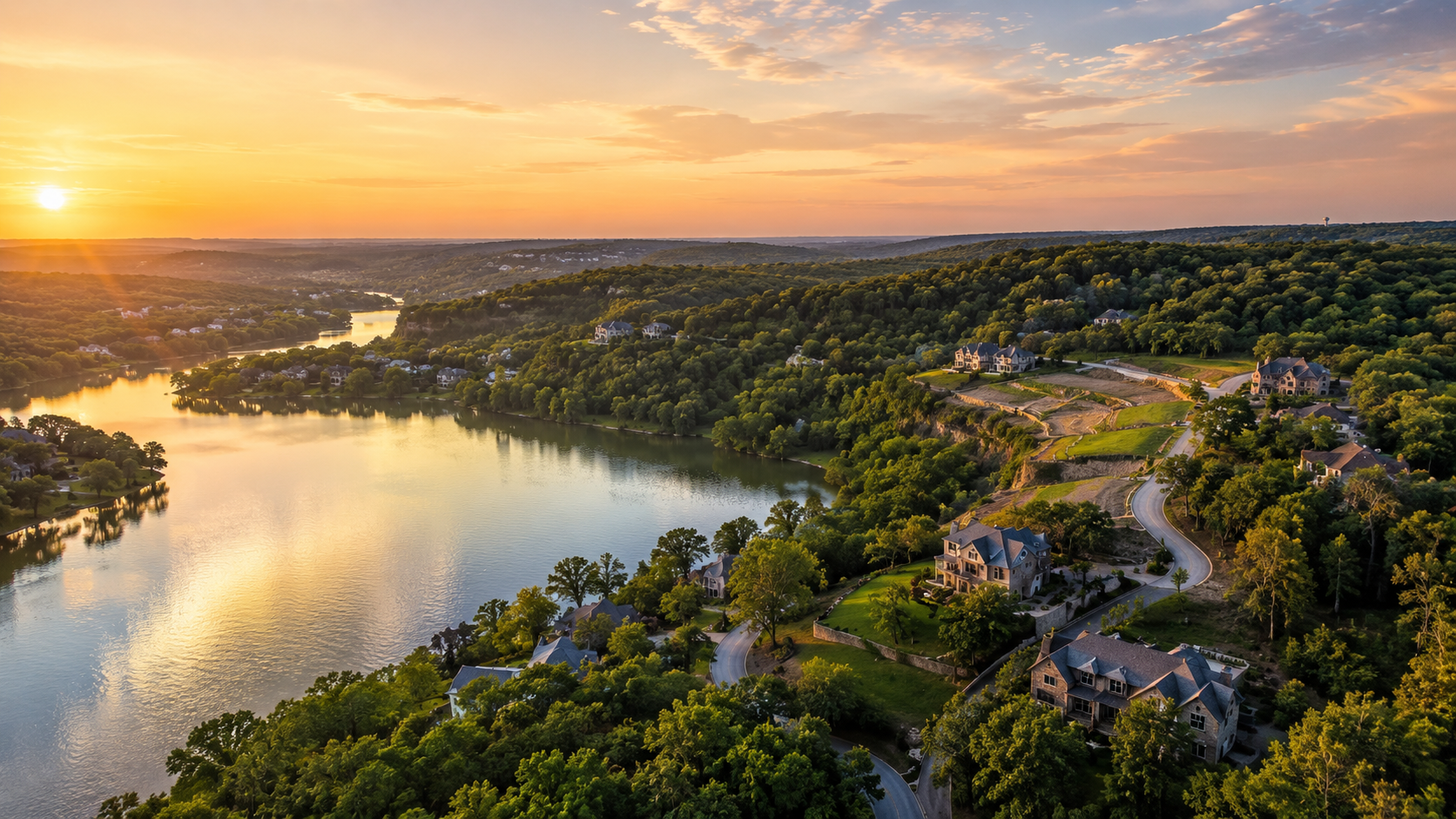 Aerial view of Riss Lake in Parkville Missouri showing luxury homes, wooded bluff lots, and private lakefront scenery that contributes to long-term home value appreciation. Aerial view of Riss Lake in Parkville Missouri showing luxury homes, wooded bluff lots, and private lakefront scenery that contributes to long-term home value appreciation.
