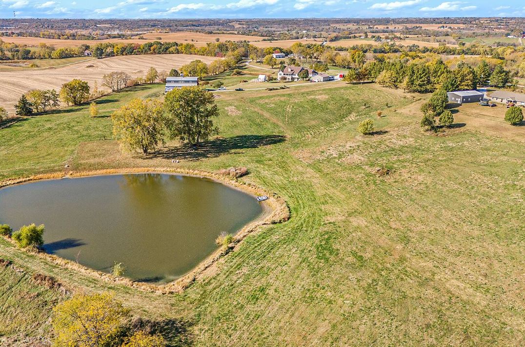 Aerial drone view of Free Bird Farms in Agency Missouri showing the private pond, rolling pastures, barn, and farmhouse surrounded by open countryside near Kansas City Aerial drone view of Free Bird Farms in Agency Missouri showing the private pond, rolling pastures, barn, and farmhouse surrounded by open countryside near Kansas City