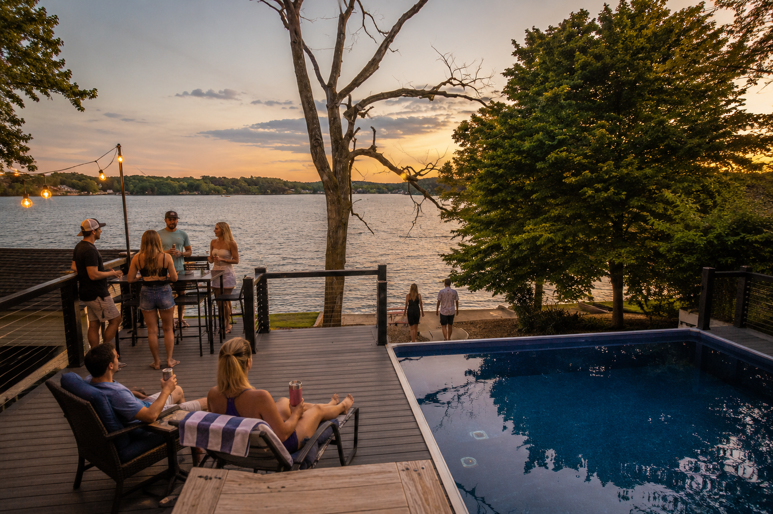 Lake Ozark vacation rental with private pool, spacious deck, lake views, and guests relaxing before walking to Shady Gators, Lazy Gators, and H. Toads. Lake Ozark vacation rental with private pool, spacious deck, lake views, and guests relaxing before walking to Shady Gators, Lazy Gators, and H. Toads.