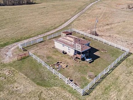 Close aerial view of the fenced utility structure at 18211 Plattsburg Road with electric and water already on-site