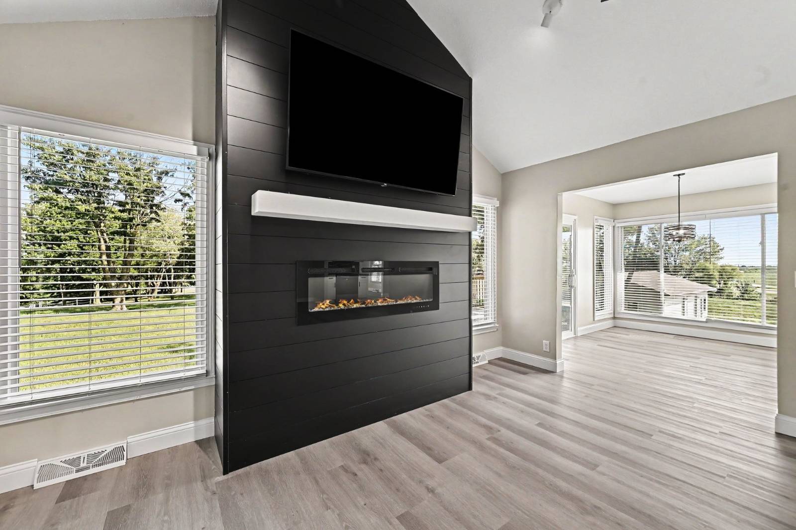 Black statement fireplace wall in renovated living room