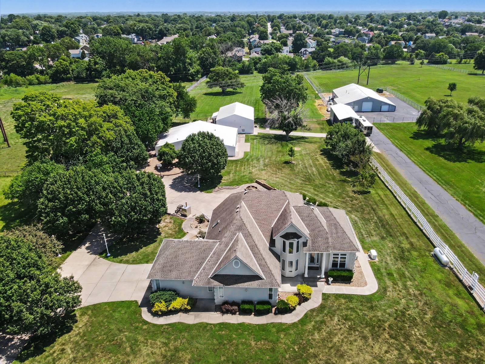 Aerial view of 903 Doc Henry Road in Greenwood, Missouri, showing the main home, 8.29-acre grounds and three outbuildings Aerial view of 903 Doc Henry Road in Greenwood, Missouri, showing the main home, 8.29-acre grounds and three outbuildings