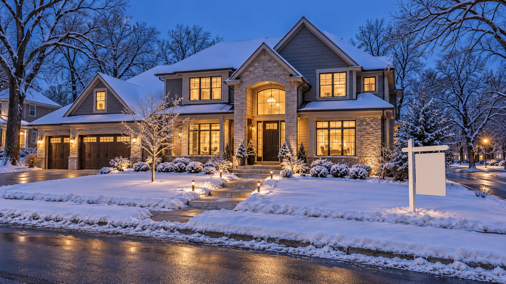 Two-story Kansas City-style home covered in fresh snow at dusk, with warm glowing windows, a cleared walkway, path lights, and a blank yard sign. Two-story Kansas City-style home covered in fresh snow at dusk, with warm glowing windows, a cleared walkway, path lights, and a blank yard sign.