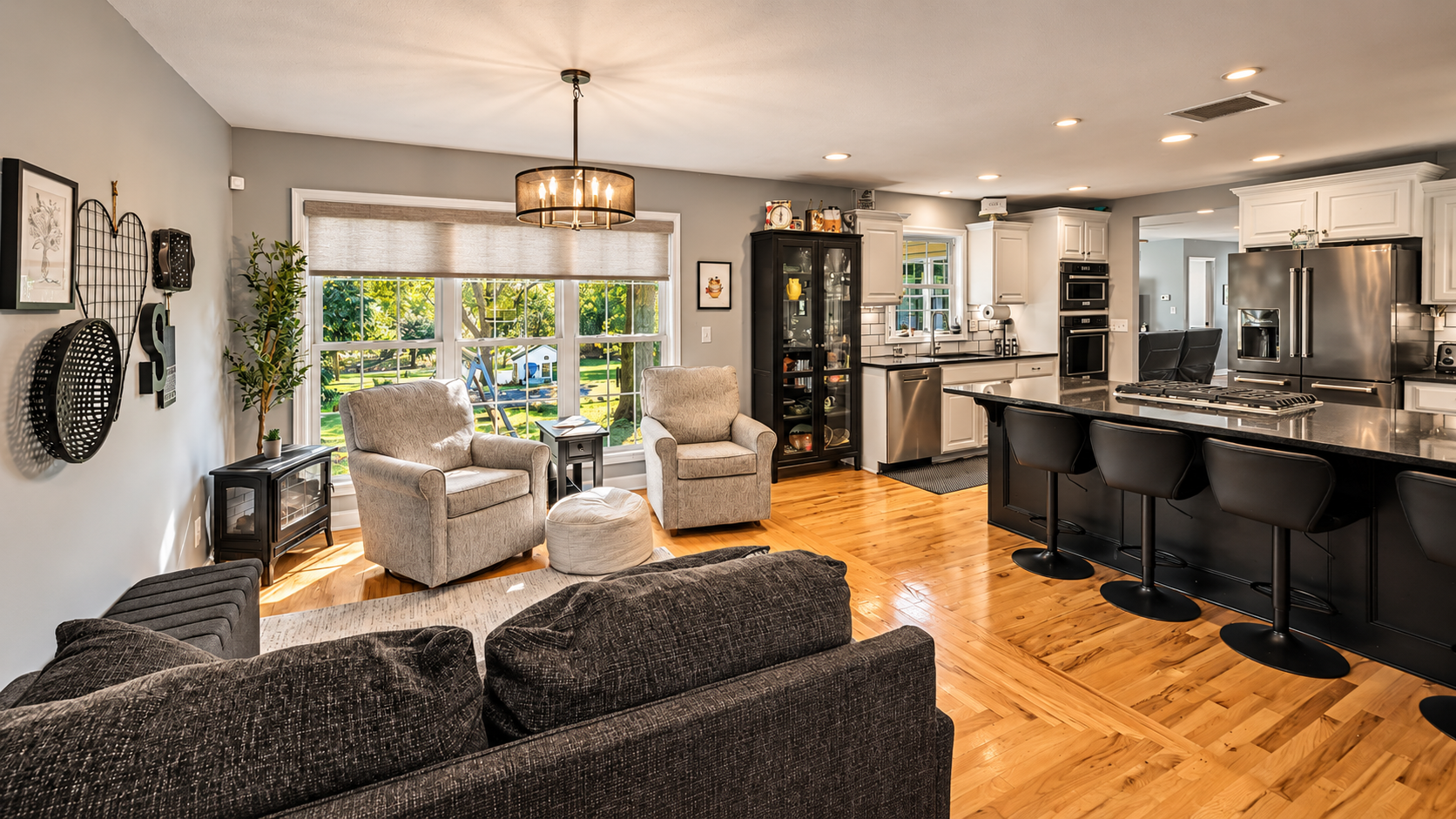 Open living area connected to an updated kitchen with island seating in a Merriam KS ranch home.
