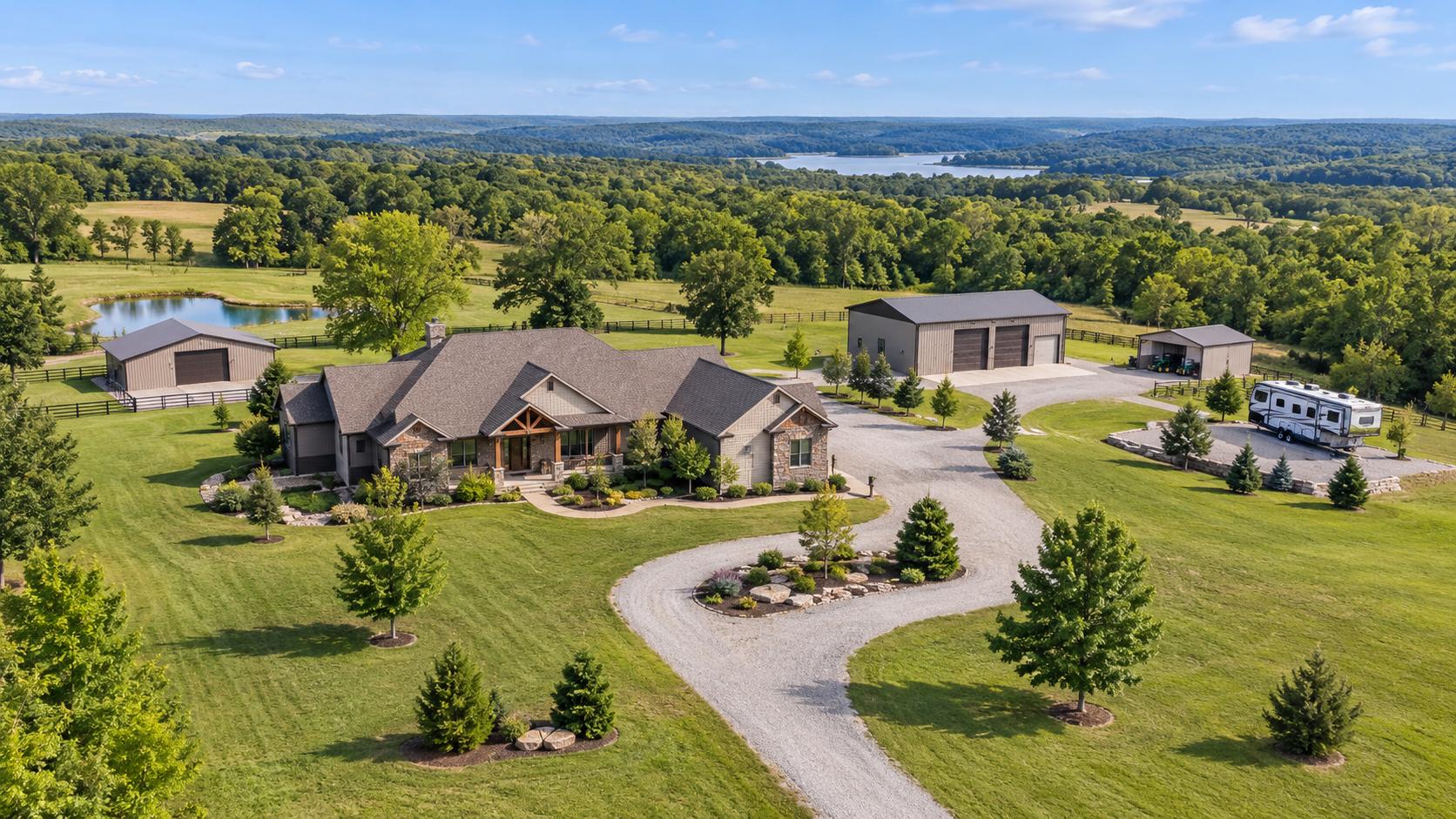 Aerial view of a Missouri acreage property with a large home, detached outbuildings, gravel drive, open lawn, and RV parking area. Aerial view of a Missouri acreage property with a large home, detached outbuildings, gravel drive, open lawn, and RV parking area.