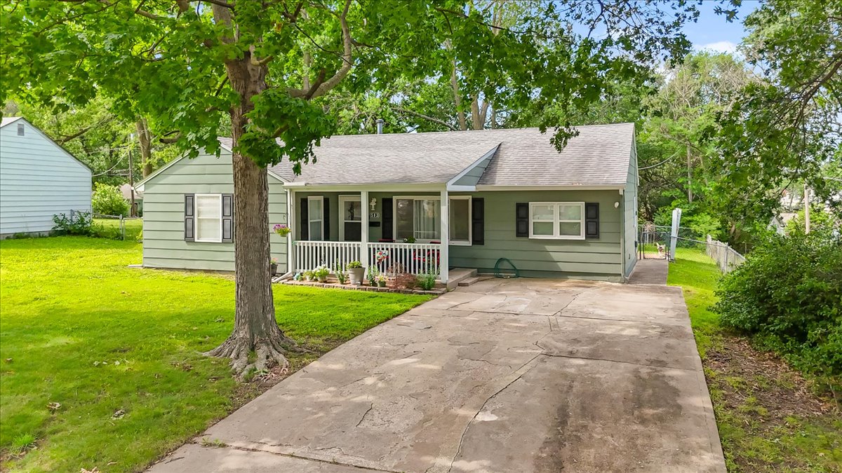 Long concrete driveway and mature shade tree