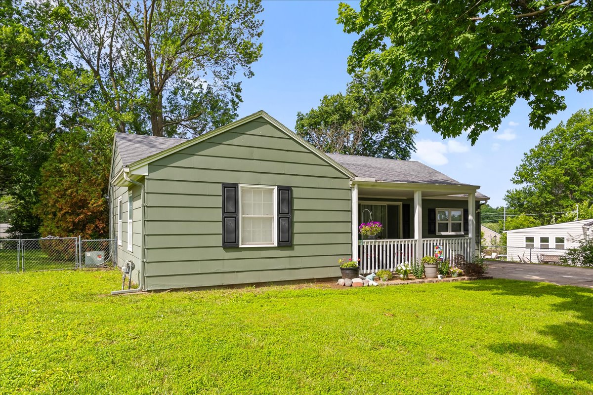 Front of 503 NE 67th Terrace with white porch railing and black shutters