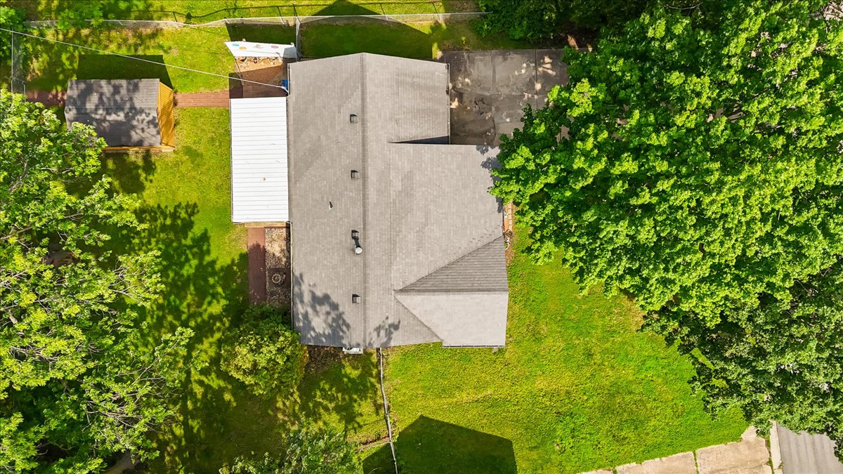 Aerial view of home, driveway and mature trees