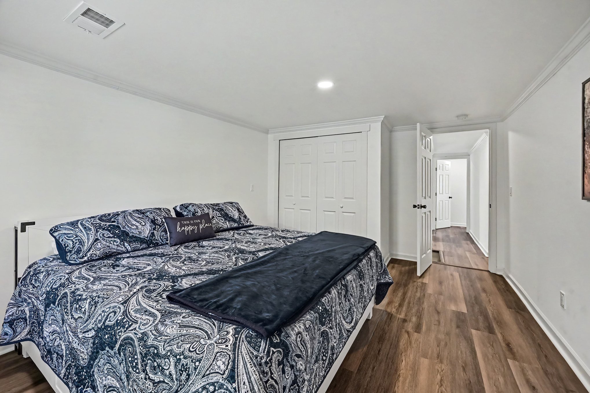 King bedroom with double closet and hallway view
