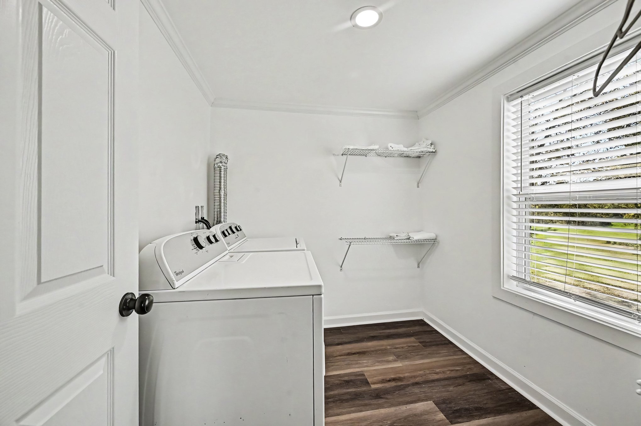 Second-floor laundry room with washer, dryer and shelving