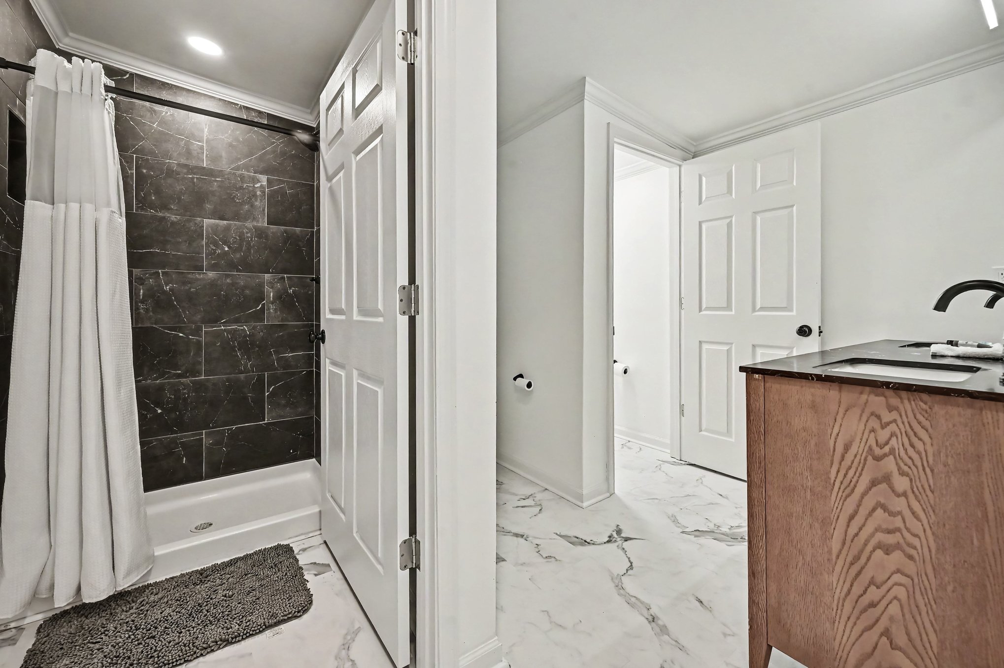 Tiled shower room off the double vanity bath