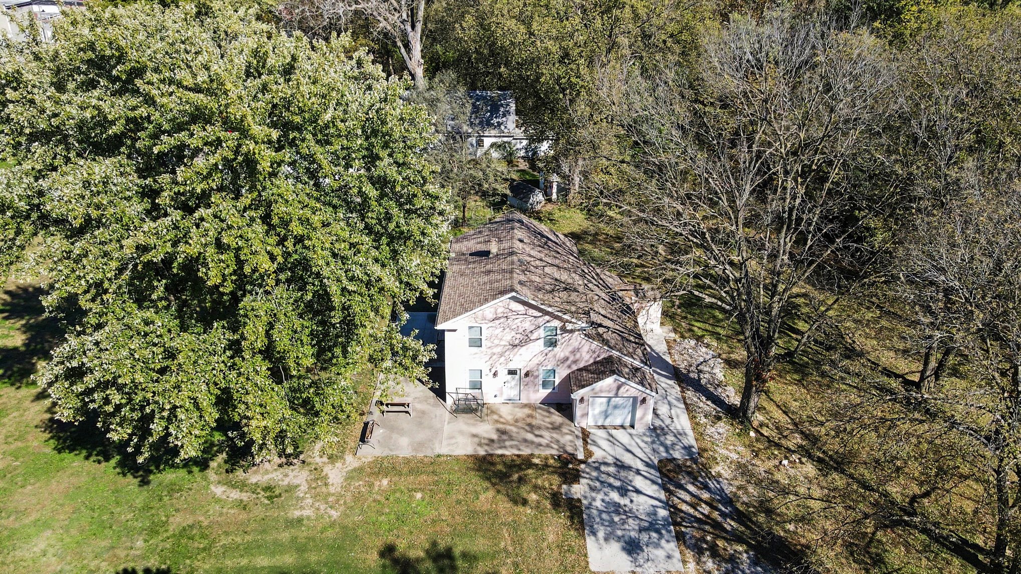 Overhead aerial of the home, driveway and large shade tree