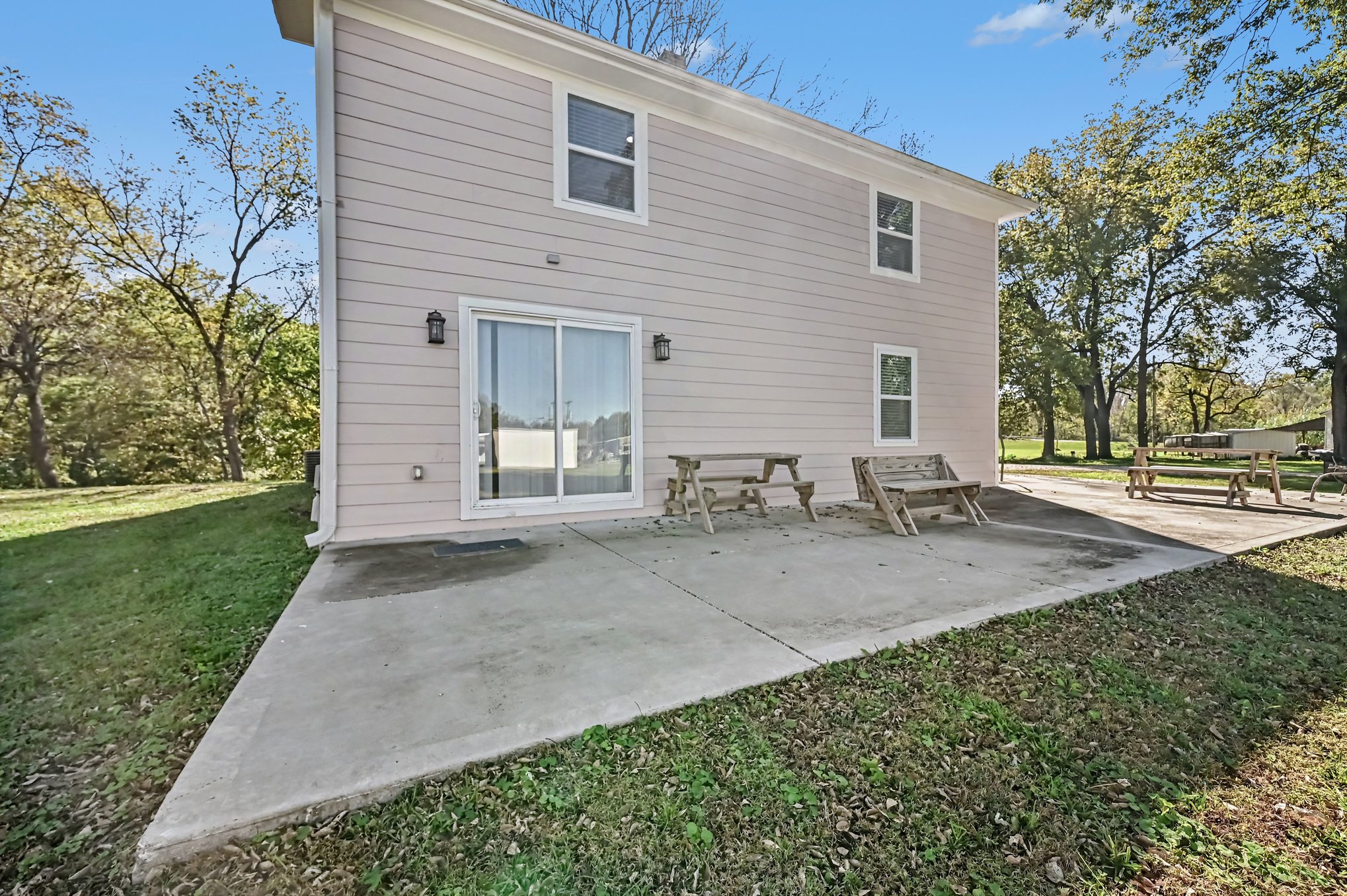 Rear patio with sliding glass door and picnic seating