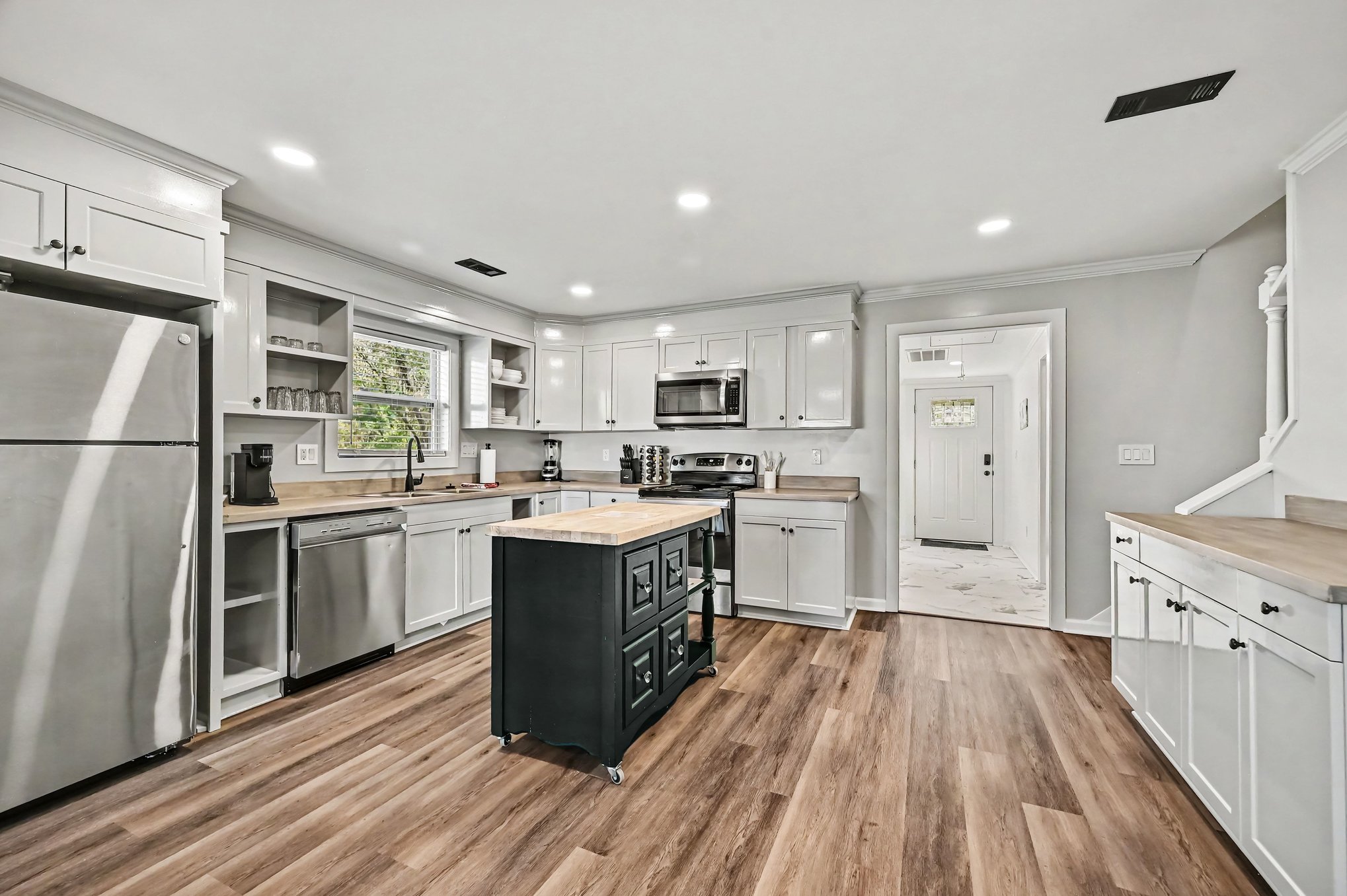 Kitchen with stainless refrigerator, dishwasher, range and microwave